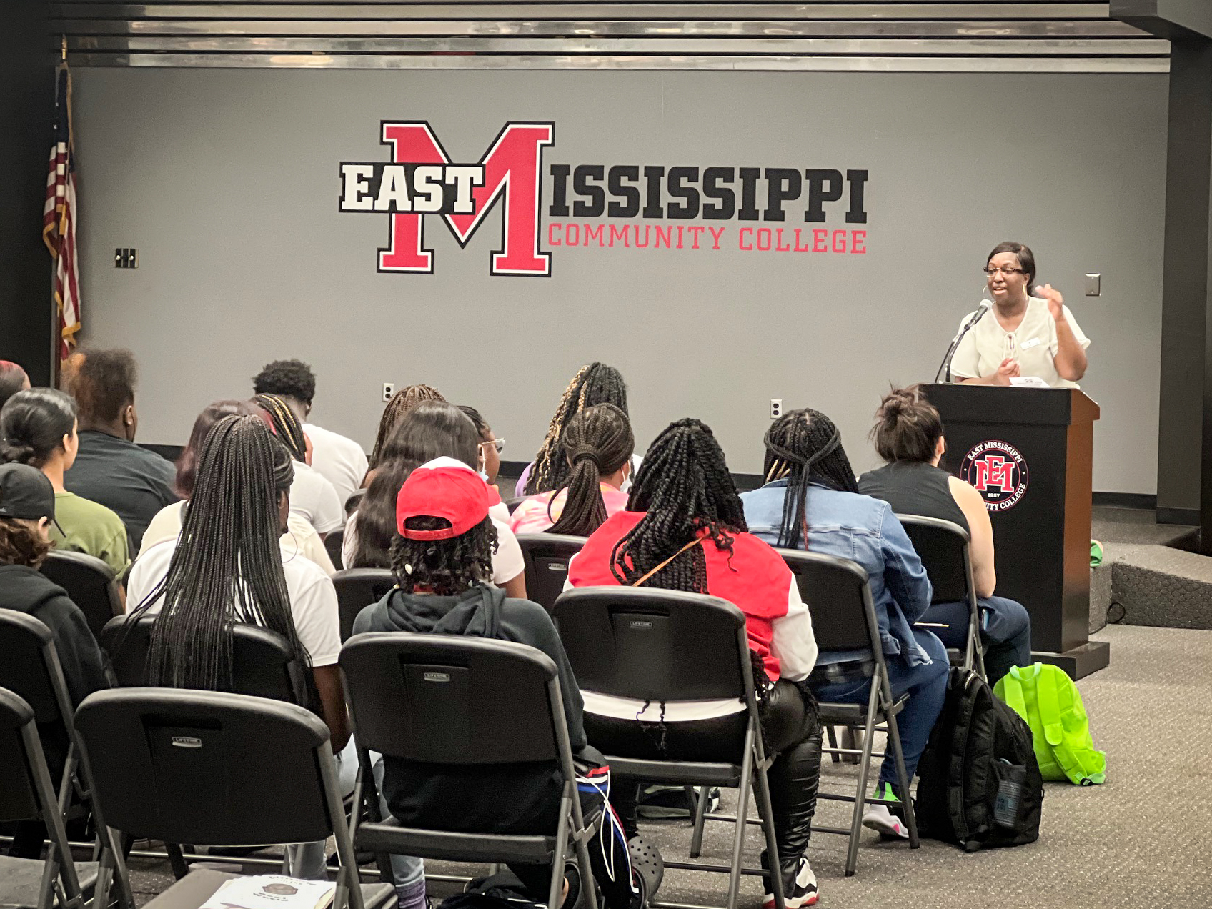 A teacher standing behind a podium at East Mississippi Community College, teaching to a room full of students.