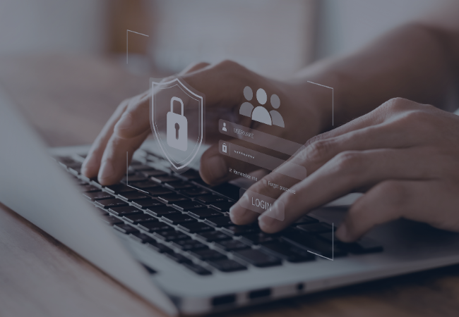 Hands typing on a laptop keyboard.