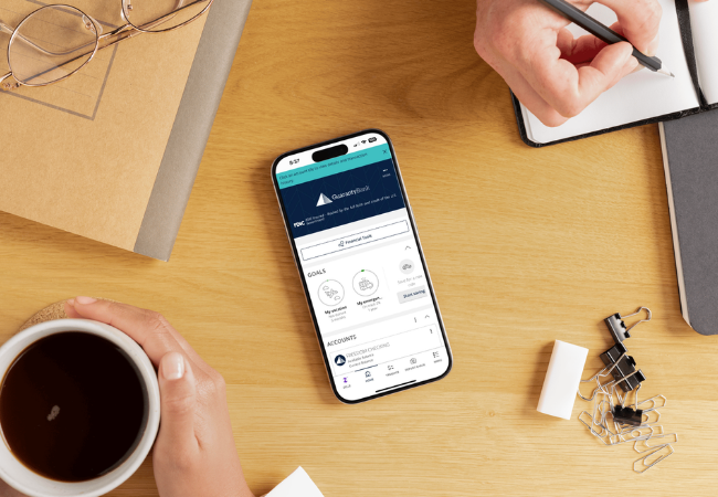 A picture of a phone on a desk with the MyGBT app open.