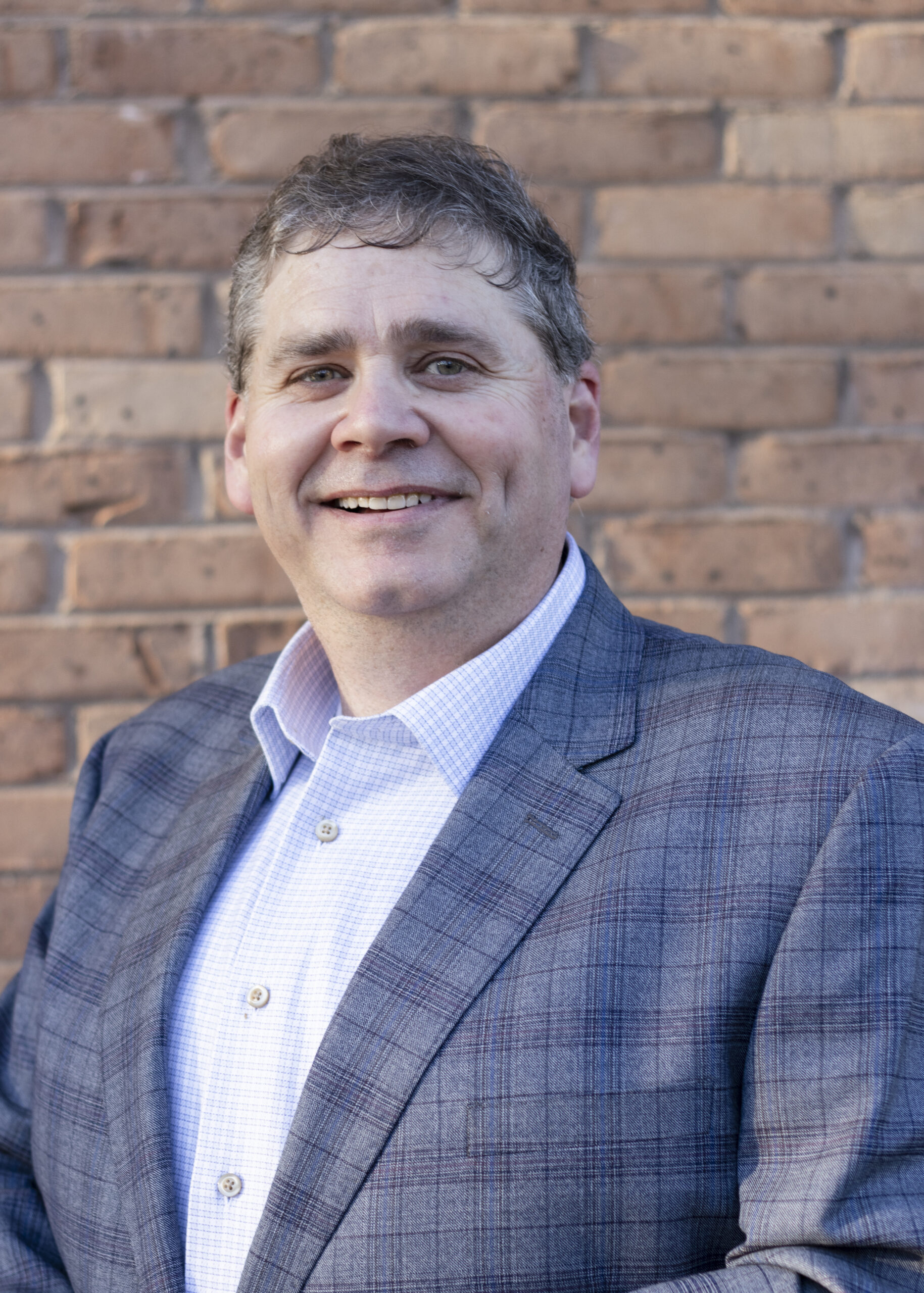 Head shot of Paul Townsend. Man in blue plaid suit jacket.
