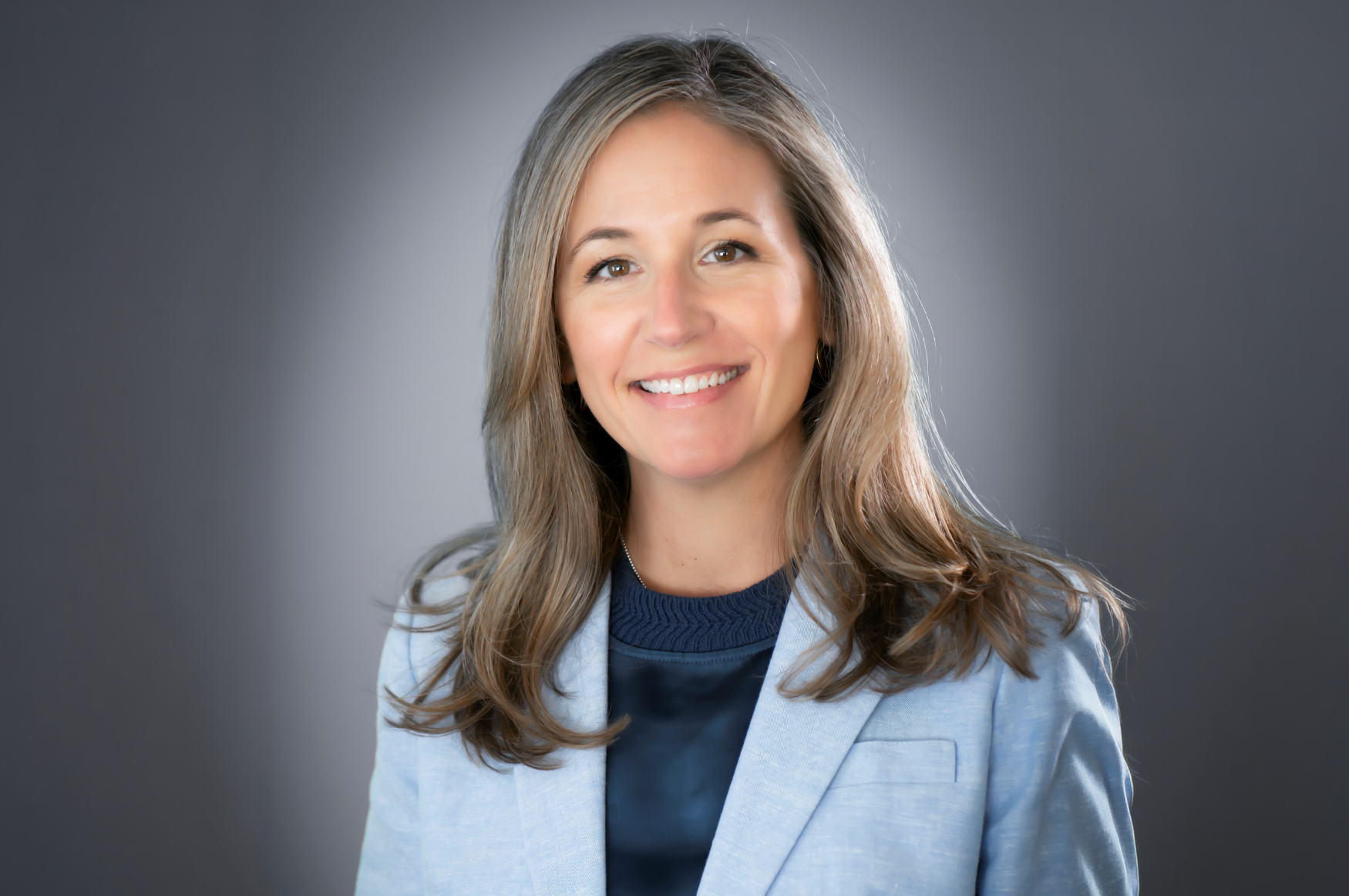 Headshot of Melissa Brady. Woman in light blue blazer.